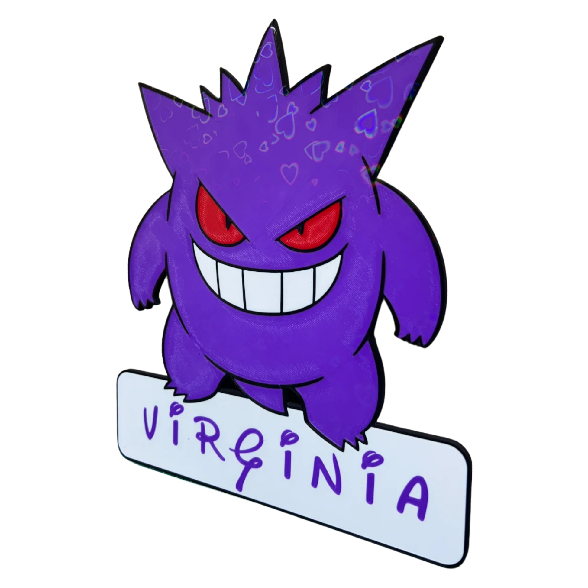 Aplique decorativo de Gengar Pokémon con el nombre "VIRGINIA" en la base, visto desde un ángulo, resaltando los detalles de su forma y el patrón.