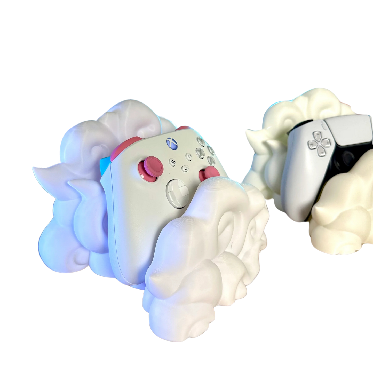 Par de soportes para mandos gaming en forma de nube, uno sosteniendo un mando Xbox personalizado y otro un mando PS5, ambos sobre fondo blanco.